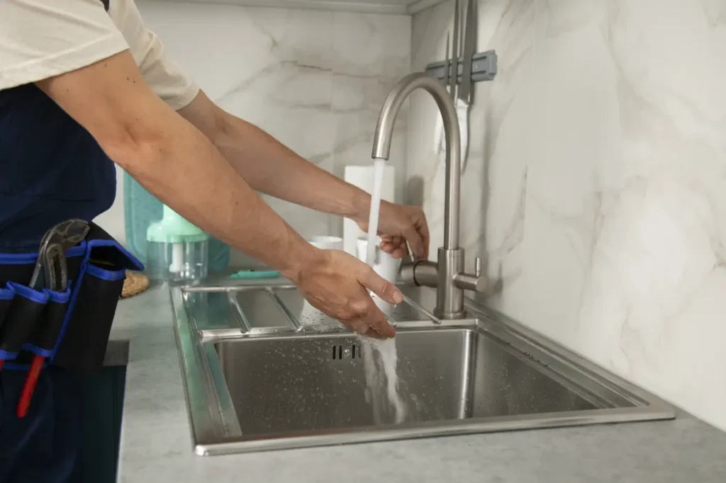 plumber working on faucet